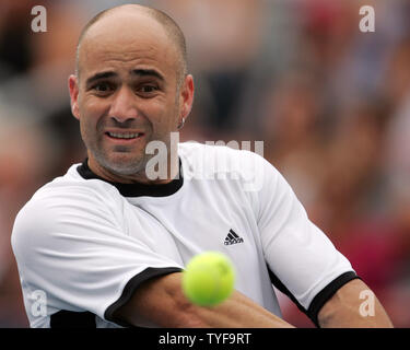 American Andre Agassi returns a shot to Spain's Rafael Nadal in the final match of the Rogers Cup men's tennis ATP masters in Montreal on August 14, 2005. Nadal,19, won the tournament 6-3, 4-6, 6-2. (UPI Photo / Grace Chiu) Stock Photo