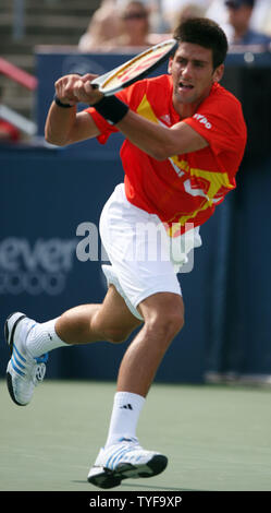 Novak Djokovic of Serbia reaches for a backhand to Roger Federer of Switzerland in the finals of the Rogers Cup ATP Masters Series at Uniprix Stadium in Montreal on August 12, 2007.  Djokovic defeated the top-ranked Federer 7-6(2), 2-6, 7-6(2) to lead the U.S. Open Series of tournaments. (UPI Photo/Grace Chiu). Stock Photo