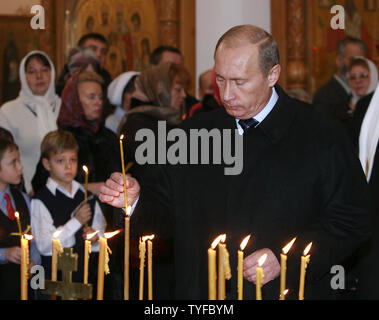 Russian President Vladimir Putin places a candle during a memorial service in Butovo, a site south of Moscow, on October 30, 2007. The Butovo firing range was used for executions from 1930 until after Stalin's death in 1953. Some 20,000 people, including priests and artists, were killed there in 1937-38 alone. (UPI Photo/Anatoli Zhdanov). Stock Photo