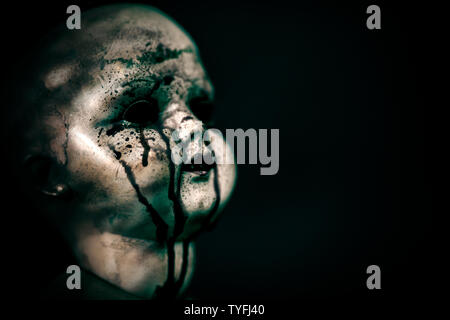 Creepy bloody doll in the dark Stock Photo