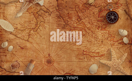 Old marine map with shells, a bottle with a message and an old compass. Copy space in the middle. Stock Photo