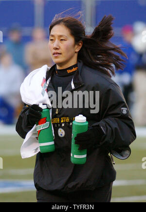 Pittsburgh Steelers trainer Ariko Iso watches a game replay on the