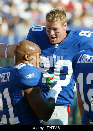 New York Giants runningback Tiki Barber leaps over defenders in week 15 at  Giants Stadium in East Rutherford, New Jersey on December 17, 2005. The New  York Giants defeated the Kansas City