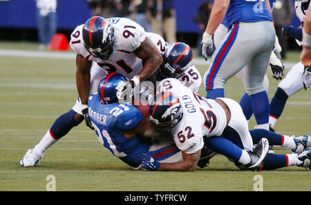 New York Giants runningback Tiki Barber leaps over defenders in week 15 at  Giants Stadium in East Rutherford, New Jersey on December 17, 2005. The New  York Giants defeated the Kansas City