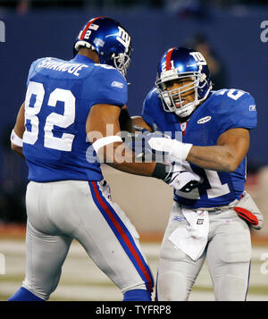 New York Giants runningback Tiki Barber takes a hand off from Eli Manning  in week 13 at Giants Stadium in East Rutherford, New Jersey on December 4,  2005. The New York Giants