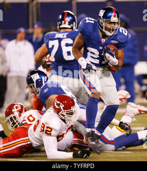 New York Giants runningback Tiki Barber takes a hand off from Eli Manning  in week 13 at Giants Stadium in East Rutherford, New Jersey on December 4,  2005. The New York Giants