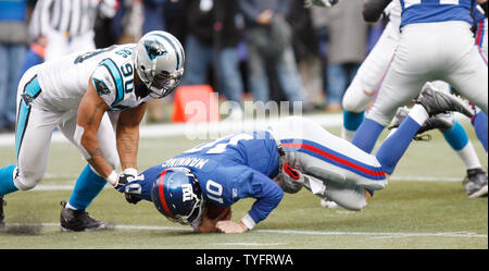 The Panthers' Julius Peppers (90) and Jordan Gross (69) exchange high fives  smelling victory with under two minutes left in the game as the Panthers  move onto the Super Bowl in a