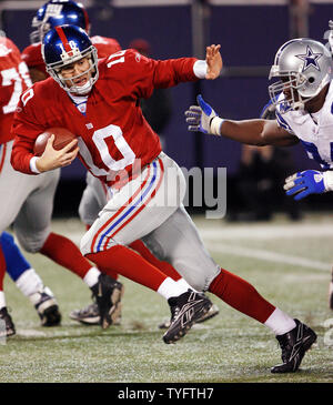 New York Giants Eli Manning scrambles away from pressure in the 3rd quarter at Giants Stadium in East Rutherford New Jersey on December 3 2006. The Dallas Cowboys defeated the New York