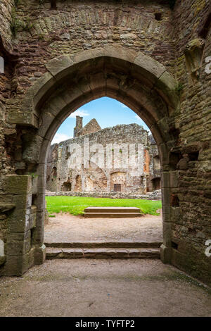 A view through the South Gate arches into the Fountain Court and Chapel at Raglan Castle, Wales Stock Photo