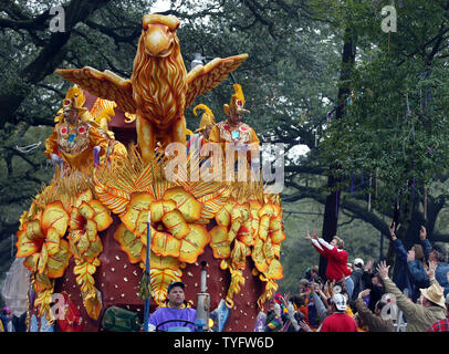 Revelers reach for beads from a float as the Rex parade rolls  down St. Charles Avenue  in Uptown New Orleans on  February 24, 2004, Mardi Gras.   Fat Tuesday is the culmination of the Carnival season, which ends at midnight.   (UPI  Photo / A.J. Sisco) Stock Photo