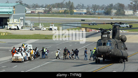 Hurricane Katrina refugees from New Orleans arrive at the New Orleans airport with their belongings on Sept. 4, 2005. Although most of the displaced persons have been evacuated from the dry areas of the city, hundreds remaining in outlying areas continue to be rescued by helicopter and by boat.   (UPI Photo/A.J. Sisco) Stock Photo