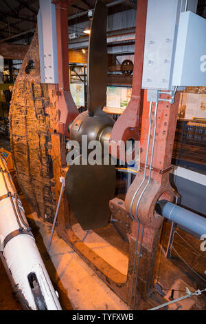 The rudder, lifting frame and screw propeller of the SS Great Britain inside The Dockyard Museum at Brunel's steam ship in Bristol. UK. Raising the propeller was an 1857 modification for efficiency in the water when sailing under the power of wind. The lifting frame was removed to take the ship back to its original state. (109) Stock Photo