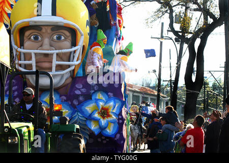 Crowds beg for beads and other trinkets as a football-themed Carnival parade float rolls down St. Charles Avenue in New Orleans  January 27, 2008. Dozens of parades and other Carnival events lead up to Mardi Gras, which is February 5 this year.  (UPI Photo/A.J. Sisco) Stock Photo