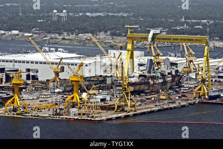 Oil containment boom, front right, protects the Northrop Grumman Shipyard in Pascagoula, Mississippi, July 14, 2010. BP continued its efforts to stem the flow of oil from its Deepwater Horizon rig in the Gulf of Mexico, which exploded and sank in April. Meanwhile, Northrop Grumman announced its intention to close a shipyard in Avondale, Louisiana, by 2013, and to consolidate operations at this shipyard in Pascagoula. The announcement was bad news for Louisiana, whose tourism and commercial fishing industries have been hit hard by the spill. UPI / A.J. Sisco. Stock Photo