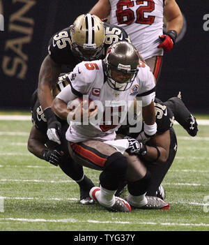 Tampa Bay Buccaneers quarterback Josh Freeman (5) scrambles up the middle for 9-yards before New Orleans Saints defensive end Martez Wilson (95) and defensive end Will Smith (91) make the tackle at the Mercedes-Benz Superdome in New Orleans, Louisiana on December 16, 2012.  UPI/A.J. Sisco Stock Photo