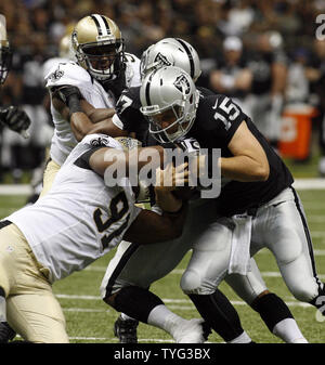 Oakland Raiders quarterback Matt Flynn (15) is sacked for 5 yards by New Orleans Saints linebacker Will Smith (91) in the second quater at the Mercedes-Benz Superdome in New Orleans, Louisiana on August 16, 2013.   UPI/A.J. Sisco Stock Photo