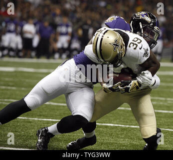 Philadelphia Eagles tight end Zach Ertz (86) is stopped on a short gain by  Baltimore Ravens defenders Tavon Young (L) and C.J. Mosley (R) during the  second half of an NFL game