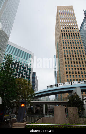 Toyo, Japen - April, 25, 2019: A train running on an overhead track through Shiodome. Stock Photo