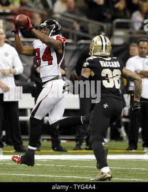 Atlanta Falcons wide receiver Roddy White (84) pulls defender Oakland  Raiders cornerback Michael Huff (24) during