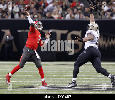 New Orleans Saints quarterback Bobby Hebert with his arm cocked back is  sacked by San Francisco 49ers defensive lineman Charles Haley during the  first quarter of their game at Candlestick Park in