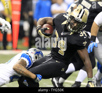 New Orleans Saints running back Tim Hightower (34) is stopped for a 4 yard gain by Detroit Lions cornerback Darius Slay (23) during the first quarter at the Mercedes-Benz Superdome in New Orleans December 21, 2015.  Photo by AJ Sisco/UPI Stock Photo