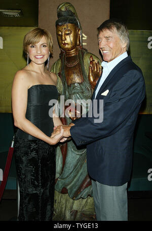 Mariska Hargitay and father Mickey Hargitay pose for pictures at the party for the 100th episode of her show'Law & Order: Special Victims Unit (SVU)' at Tao in New York on October 22, 2003.  (UPI/LAURA CAVANAUGH) Stock Photo