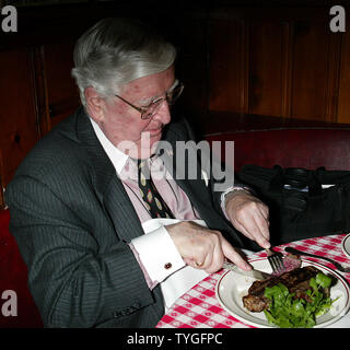 Michael Gillespie, a real estate developer from Manhattan, eats the 5 millionth steak served at Gallagher's Steak House in New York on January 14, 2004.  Gillespie is a regular at Gallagher's, dining at the restaurant weekly for the past 40 years.  He received a bottle of Dom Perignon champagne with his lunch and will receive an annual dinner for two at Gallagher's for the next 76 years (in honor of the restaurant's 76 years in business). Stock Photo