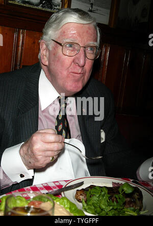 Michael Gillespie, a real estate developer from Manhattan, eats the 5 millionth steak served at Gallagher's Steak House in New York on January 14, 2004.  Gillespie is a regular at Gallagher's, dining at the restaurant weekly for the past 40 years.  He received a bottle of Dom Perignon champagne with his lunch and will receive an annual dinner for two at Gallagher's for the next 76 years (in honor of the restaurant's 76 years in business). Stock Photo