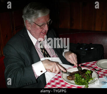 Michael Gillespie, a real estate developer from Manhattan, eats the 5 millionth steak served at Gallagher's Steak House in New York on January 14, 2004.  Gillespie is a regular at Gallagher's, dining at the restaurant weekly for the past 40 years.  He received a bottle of Dom Perignon champagne with his lunch and will receive an annual dinner for two at Gallagher's for the next 76 years (in honor of the restaurant's 76 years in business). Stock Photo