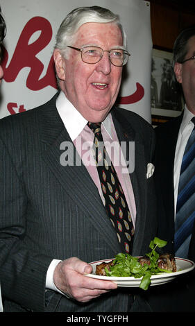 Michael Gillespie, a real estate developer from Manhattan, eats the 5 millionth steak served at Gallagher's Steak House in New York on January 14, 2004.  Gillespie is a regular at Gallagher's, dining at the restaurant weekly for the past 40 years.  He received a bottle of Dom Perignon champagne with his lunch and will receive an annual dinner for two at Gallagher's for the next 76 years (in honor of the restaurant's 76 years in business). Stock Photo