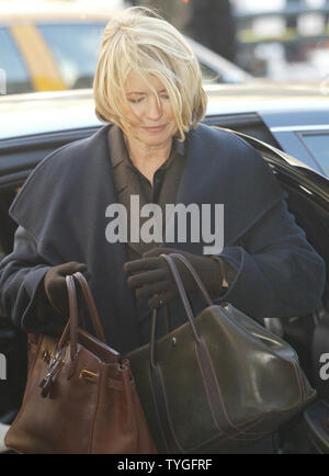 Martha Stewart can't decide which bag to carry into court as she arrives at Federal Court in New York on Jan. 20, 2004 for jury selection in her trial for improper disposal of her ImClone stocks. (UPI/Ezio Petersen) Stock Photo