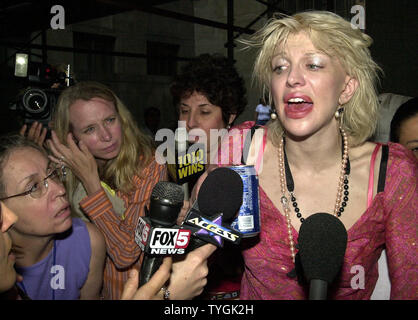 Singer Courrtney Love answers reporters questions outside Manhattan Criminal Court after appearing there on May 13, 2004 to face upgraded assault charges stemming from a alleged tossing of a mircophone stand into a crowd at a New York concert. (UPI/Ezio Petersen) Stock Photo