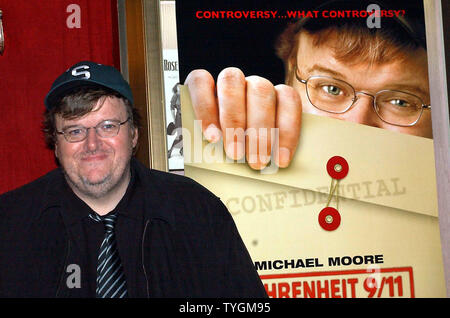 Academy Award winning director/documentarian Michael Moore poses on June 14, 2004 with the poster for his new controversal film on President Bush entitled ' Fahrenheit 9/11' (UPI Photo/Ezio Petersen) Stock Photo