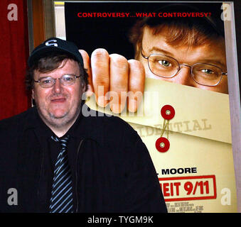 Academy Award winning director/documentarian Michael Moore poses on June 14, 2004 with the poster for his new controversal film on President Bush entitled ' Fahrenheit 9/11' (UPI Photo/Ezio Petersen) Stock Photo