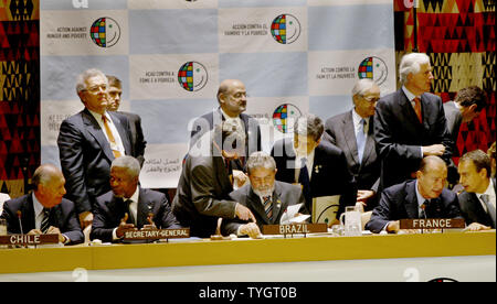 Richard Lagos Escobar, left, president of Chile, talks with Secretary General Kofi Annan, second left, at the start of the Action Against Poverty summit where they are joined by Brazil's president Luis Inacio Lula da Silva, seated in center, Jacques Chirac, seated second right, president of France and Spains' president Jose Luis Rodriguez Zapatero, seated right, at the United Nations on September 20, 2004 in New York City.  (UPI Photo/Monika Graff Stock Photo