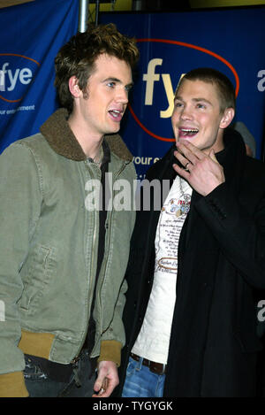 'One Tree Hill' castmembers Tyler Hilton (left) and Chad Michael Murray sign copies of the shows soundtrack CD at FYE in New York on January 25, 2005.  (UPI Photo/Laura Cavanaugh) Stock Photo