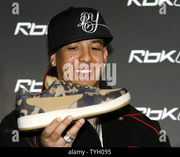 Daddy Yankee poses looks at his new sneaker at the Reebok RBK Now Playing  press conference at Marquee in New York City on March 8, 2006. (UPI  Photo/John Angelillo Stock Photo - Alamy