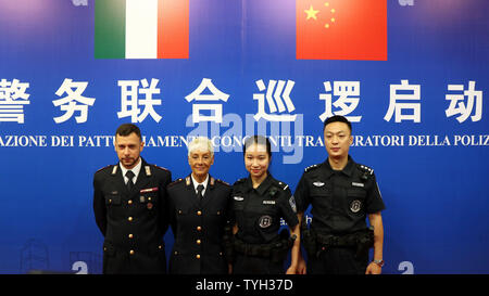 (190626) -- GUANGZHOU, June 26, 2019 (Xinhua) -- Chinese and Italian police officers pose for a group photo during the launching ceremony of the joint patrol between Chinese and Italian police held in Guangzhou, capital of south China's Guangdong Province, June 26, 2019. Italian police officers on Monday began patrolling tourist sites in China, with their local counterparts, after a launching ceremony held in Beijing. The joint patrol, the third such exercise between Chinese and Italian police in China, will last until July 5 in four cities: Beijing, Shanghai, Chongqing and Guangzhou. (Xin Stock Photo