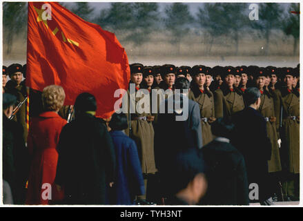 President and Mrs. Nixon's arrival in Peking, China. Nixon reviewing troops at the airport.; Scope and content:  Pictured: Pat Nixon, Richard M. Nixon, Chou En-Lai. Subject: NIxon's trip to China. Stock Photo