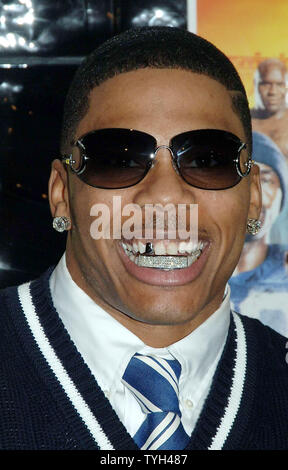 Actor/rap singer Nelly shows off his diamond encrusted teeth while posing at the May 24, 2005 New York premiere for his new film 'The Longest Yard' which is based on the 1974 film of the same title.  (UPI Photo/Ezio Petersen Stock Photo