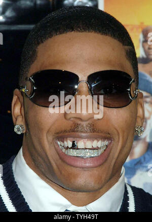 Actor/rap singer Nelly shows off his diamond encrusted teeth while posing at the May 24, 2005 New York premiere for his new film 'The Longest Yard' which is based on the 1974 film of the same title.  (UPI Photo/Ezio Petersen Stock Photo