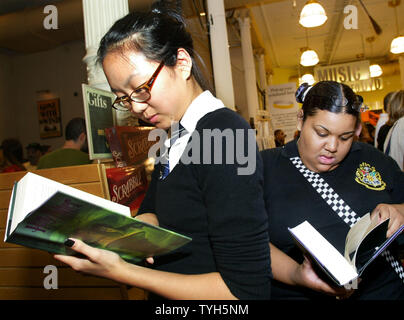 Klaudia Chang, left, and Lillian Brinkley get their first look at 'Harry Potter and the Half-Blood Prince,'  which was released at midnight, as they wait in line to purchase the book on July 15, 2005 in New York City. Thousands of bookstores nationwide stayed open late for the anticipated midnight release of the sixth Harry Potter book of which 10.8 million copies have already been printed. (UPI Photo/Monika Graff) Stock Photo