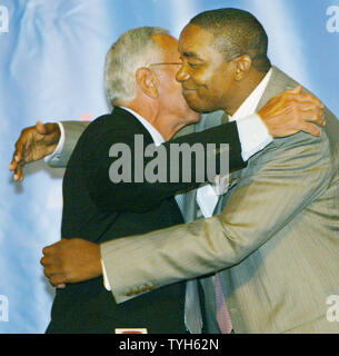 Basketball Hall of Famer Larry Brown talks, left, and Isisah Thomas, president of the New York  Knicks, embrace as Brown is announced as the team's new head coach during a press conference at Madison Square Garden on July 28, 2005 in New York City. Brown, former coach for the Detroit Pistons, will be the highest paid basketball coach ever, receiving over $10 million a year.  (UPI Photo/Monika Graff) Stock Photo