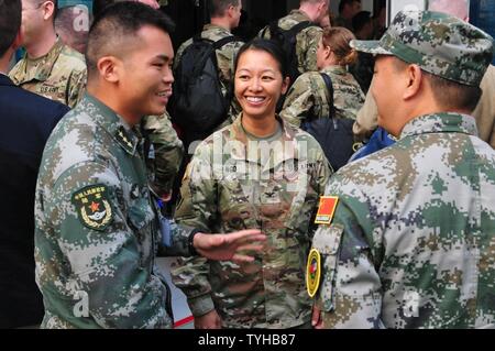 Col. Danielle Ngo, commander of the 130th Engineer Brigade, shares a laugh with members of the People’s Liberation Army of the Republic of China while on break during the U.S.-China Disaster Management Exchange’s Expert Academic Dialogue November 9 in Kunming, China. The annual United States Army Pacific (USARPAC) Security Cooperation event with the People's Liberation Army (PLA) is an opportunity to share Humanitarian Assistance/Disaster Relief lessons learned from real world events and enhance U.S. and Chinese disaster management capabilities. Stock Photo