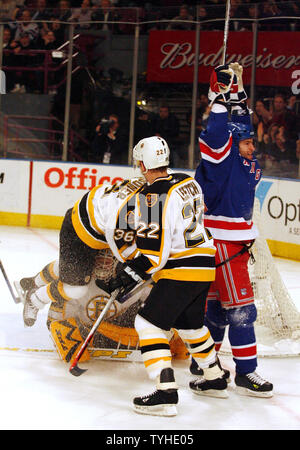 New York Rangers (18) Dominic Moore celebrates a goal while Boston Bruins (22) Brian Leetch watches at Madison Square Garden in New York City on March 20, 2006. The New York Rangers defeated the Boston Bruins 5-2.    (UPI Photo/John Angelillo) Stock Photo