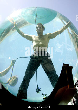Magician and performance artist David Blaine is photographed by the media as he begins his seven-day stay in a water tank situated outside at the Lincoln Center for the Performing Arts in New York City on May 1, 2006. Blaine will breath through an air tube as he floats around in the eight-foot acrylic sphere in full public view. (UPI Photo/Monika Graff) Stock Photo