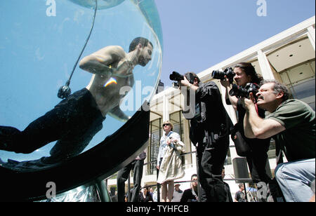 Magician and performance artist David Blaine is photographed by the media as he begins his seven-day stay in a water tank situated outside at the Lincoln Center for the Performing Arts in New York City on May 1, 2006. Blaine will breath through an air tube as he floats around in the eight-foot acrylic sphere in full public view. (UPI Photo/Monika Graff) Stock Photo