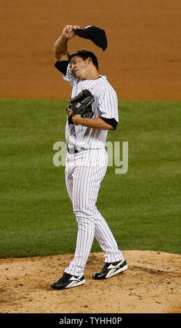 New York Yankees pitcher Scott Proctor adjusts his cap after giving up a  three-run home run to the Boston Red Sox' Jacoby Ellsbury in the 14th  inning. The Red Sox defeated the