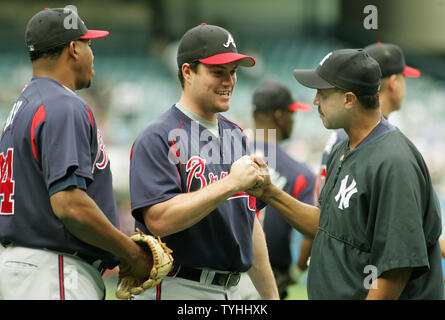 Matt Diaz, center, an outfielder with the Atlanta Braves, greets Tony Pena, right, first base coach for the New York Yankees as Diaz's teamate Jorge Sosa looks on during batting practice before their game at Yankee Stadium on June 27, 2006 in New York.  (UPI Photo/Monika Graff) Stock Photo