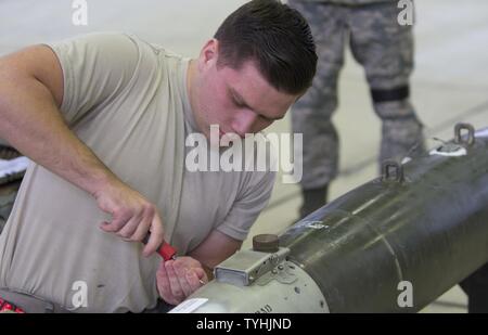 U.S. Air Force Airman 1st Class Christian Edson, 52nd Aircraft Maintenance Squadron tactical aircraft weapons systems specialist, prepares a dummy missile before loading it to an F-16 Fighting Falcon aircraft at Spangdahlem Air Base, Nov. 10, 2016. Family, friends and members of the Spangdahlem community attended the competition to see which of the two teams of three maintenance Airmen would move on to the annual load competition. Stock Photo